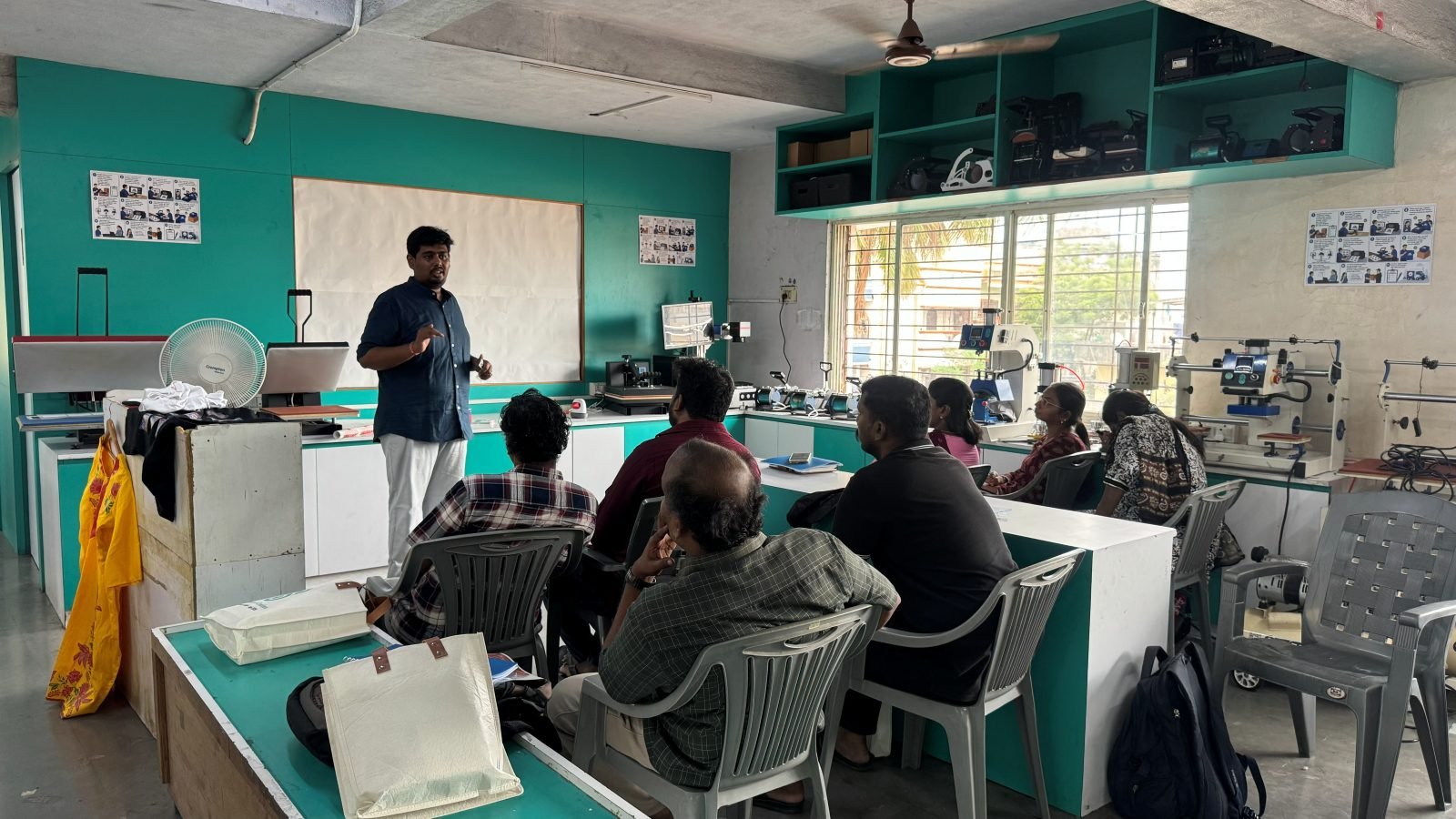 Hands-on heat press machine demonstration during the Founder's Workshop